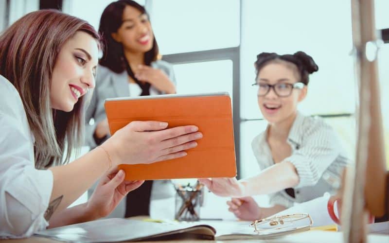 Get a study buddy and add a new skillset. Group of three woman working together looking at an iPad.